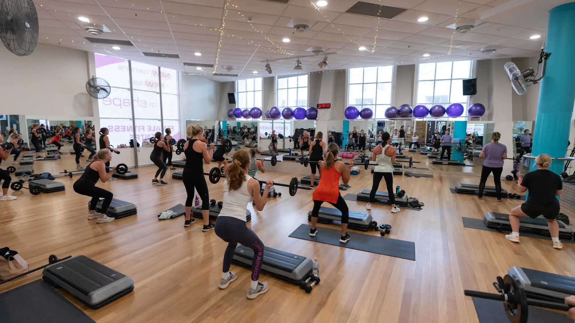 Members training in the group fitness studio at Body Shape Warringah Mall